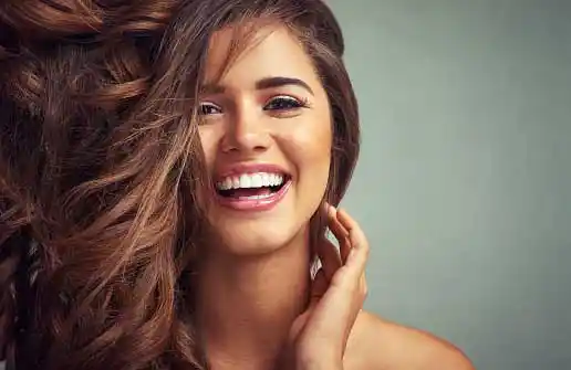 young, beautiful girl with luscious hair laughing